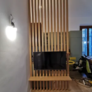 Parete a listelli di legno e arredi su misura